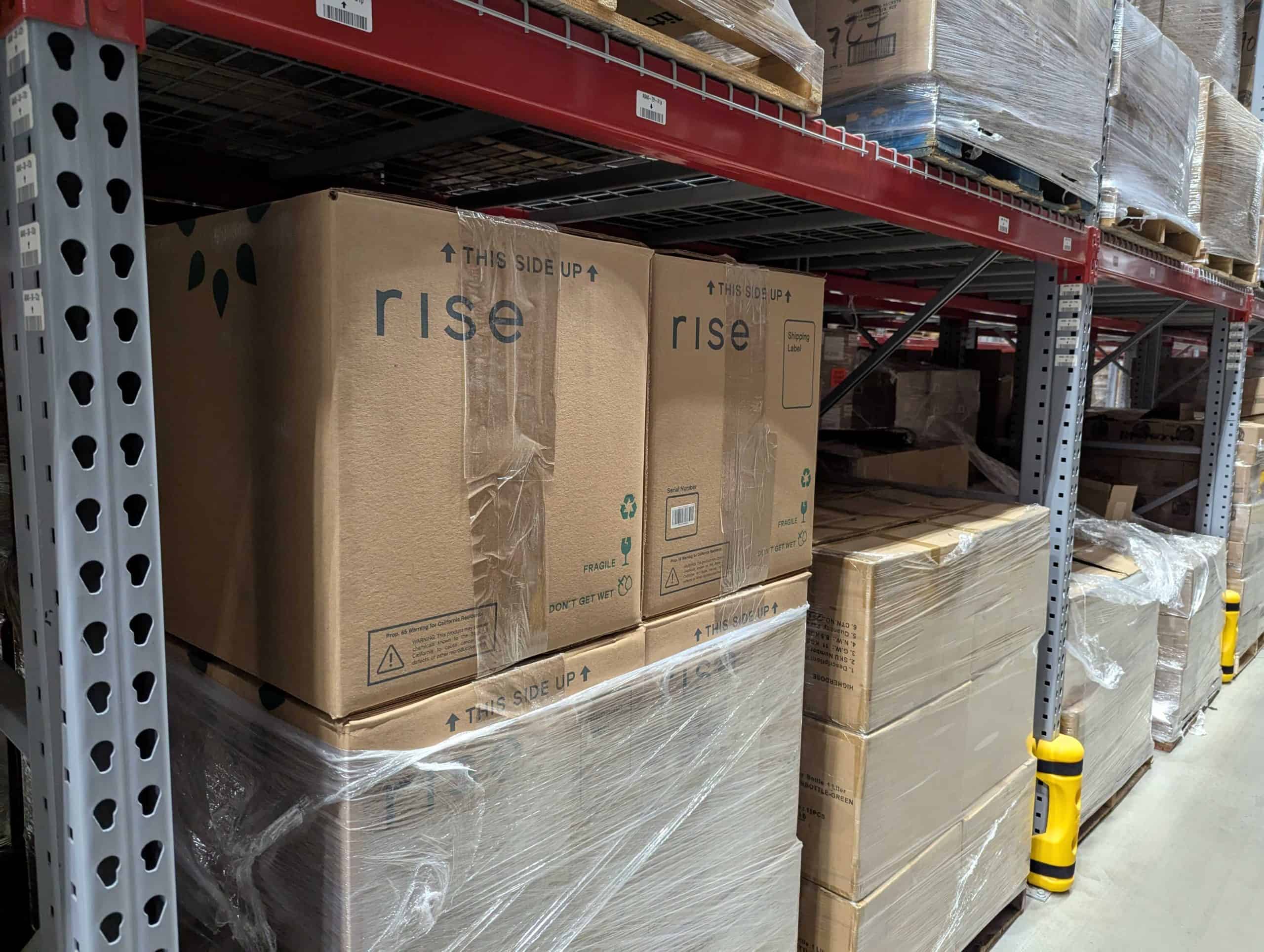 RiseGardens_LargePackage_Location Large packages in shrink wrap on a wooden pallet.