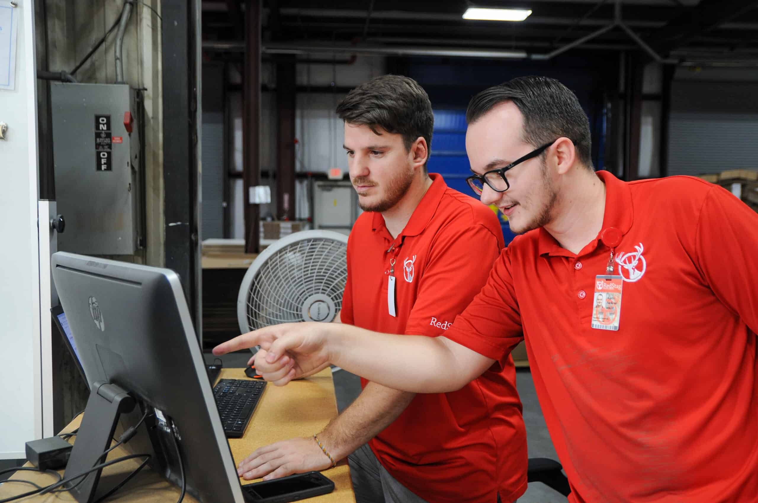 RedStag employees checking on computer RedStag employees checking on computer